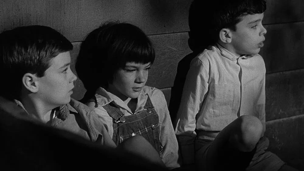 Childhood terrors: Finch, Badham, and Megna cower, terrified by the prowling Boo Radley in "To Kill a Mockingbird" / Photo courtesy of Brentwood Production.