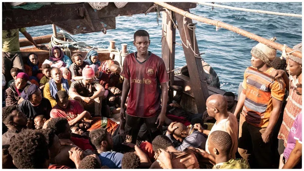 Human surge: Seydou Sarr takes a full boat of people on his shoulders in "Io Capitano" / Photo courtesy of Cohen Media Group.