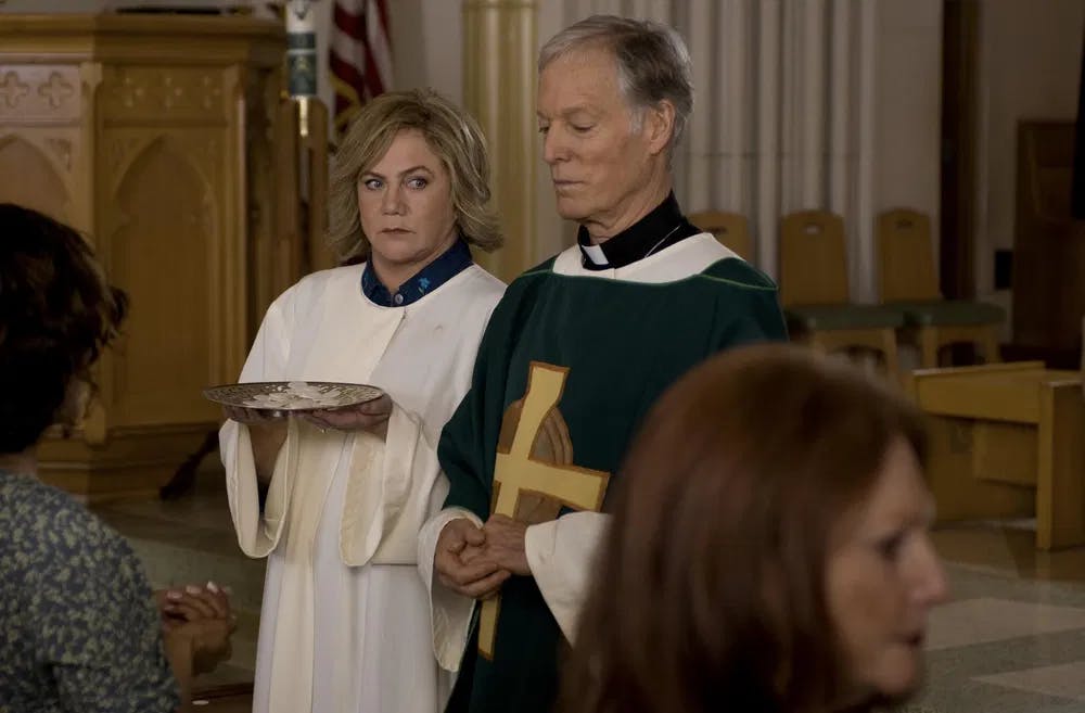 Oh, Father!: Turner gives the side-eye to Father Murphy (Richard Chamberlain) in "The Perfect Family" / Photo courtesy of Gravitas Ventures.