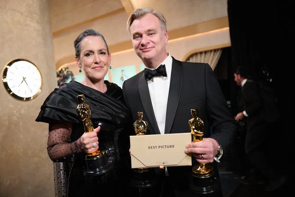 Producers Emma Thomas and Christopher Nolan pose backstage with their Best Picture Oscars for "Oppenheimer." Photo by Richard Harbaugh, courtesy of ©A.M.P.A.S.