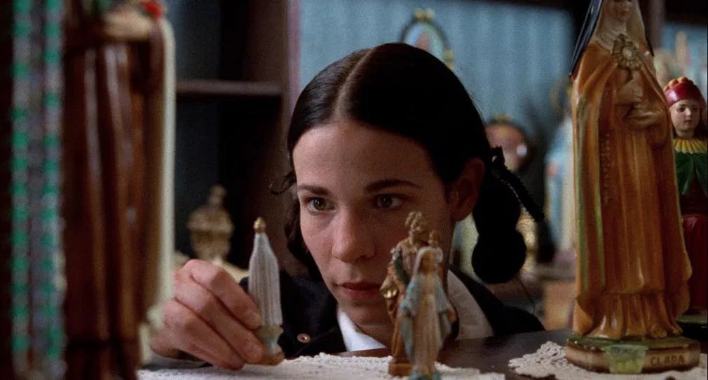 Saint maybe: Lily Taylor sets her own private altar in "Household Saints." / Photo courtesy of Kino Lorber.